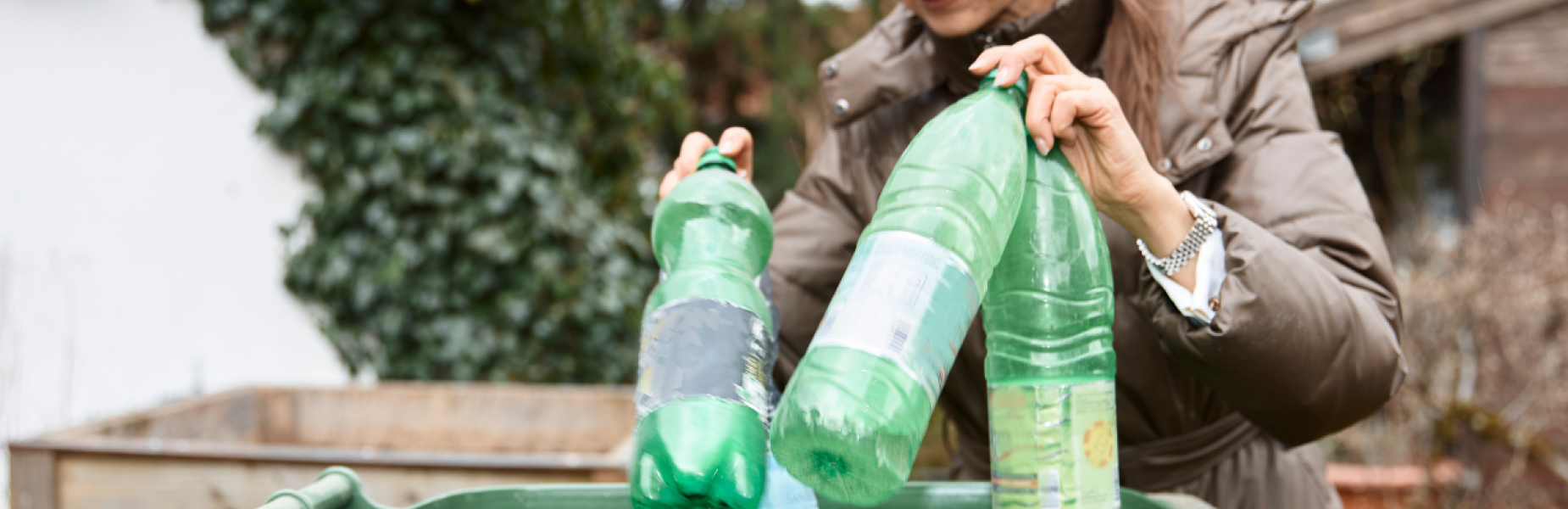A woman recycling plastic bottles