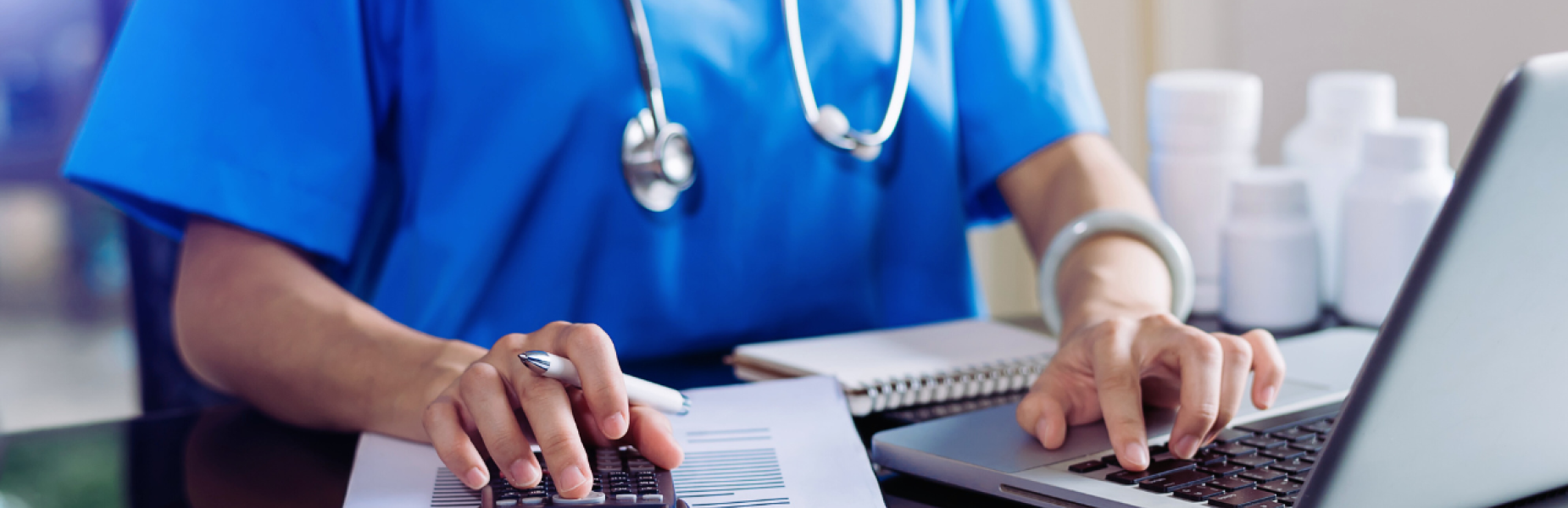Doctor working at laptop
