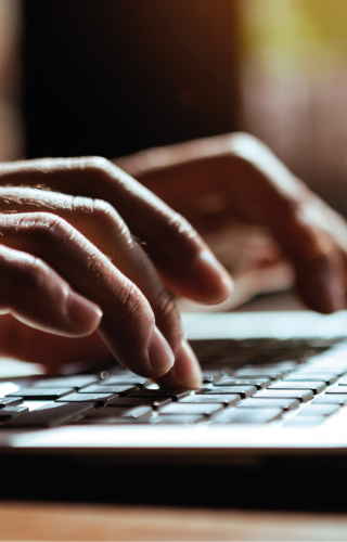 Hands typing on a keyboard