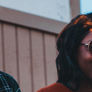 Two people sitting outside laughing 